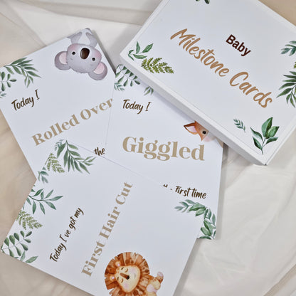 Baby milestone cards with animal illustrations and text on a light background